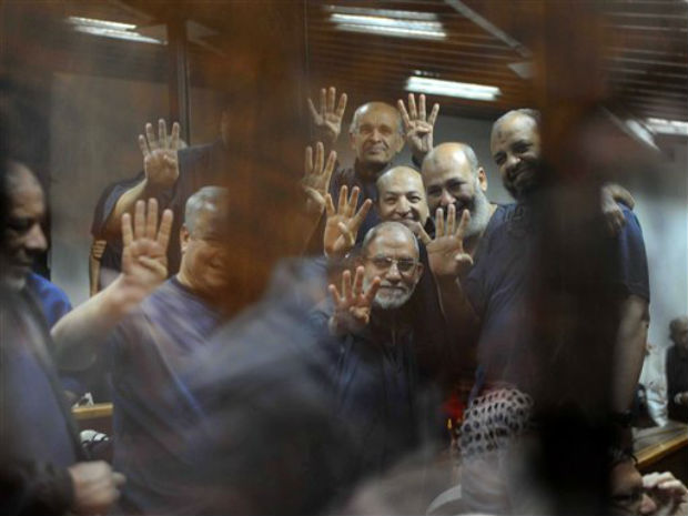 Brandishing the four-fingered symbol of Rabaah that refers to the deadly dispersal of supporters of former Egyptian President Mohammed Morsi in August 2013, senior Muslim brotherhood leaders including their spiritual leader Mohammed Badie, lower Brandishing the four-fingered symbol of Rabaah that refers to the deadly dispersal of supporters of former Egyptian President Mohammed Morsi in August 2013, senior Muslim brotherhood leaders including their spiritual leader Mohammed Badie, lower