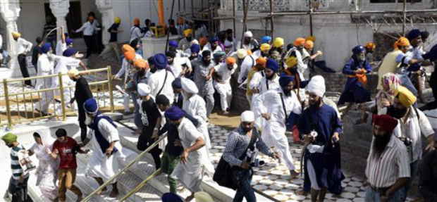 A scene of clash between SGPC supporters and a radical Sikh organisation on the 30th anniversary of Operation Bluestar, at Golden Temple Complex in Amritsar on Friday. (Photo: PTI) A scene of clash between SGPC supporters and a radical Sikh organisation on the 30th anniversary of Operation Bluestar, at Golden Temple Complex in Amritsar on Friday. (Photo: PTI)
