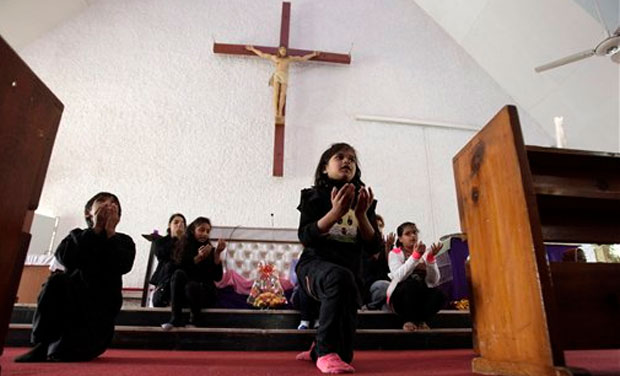 Pakistani Christian children take part in a prayers ceremony for victims killed in Tuesday's Taliban attack on a military-run school in Peshawar. (Photo: AP) Pakistani Christian children take part in a prayers ceremony for victims killed in Tuesday's Taliban attack on a military-run school in Peshawar. (Photo: AP)