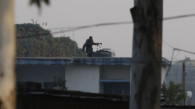 Army soldier guards atop a house outside the Indian air force base in Pathankot (Photo: AP) Army soldier guards atop a house outside the Indian air force base in Pathankot (Photo: AP)