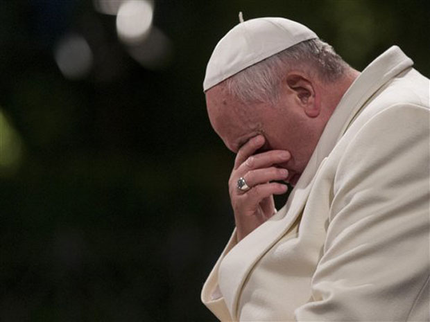 Pope Francis bows his heads and closes his eyes during the Via Crucis (Way of the Cross) torchlight procession in Rome, Friday, April 18, 2014. Pope Francis presided over a torch-lit Way of the Cross procession at the Colosseum marking Good Friday Pope Francis bows his heads and closes his eyes during the Via Crucis (Way of the Cross) torchlight procession in Rome, Friday, April 18, 2014. Pope Francis presided over a torch-lit Way of the Cross procession at the Colosseum marking Good Friday
