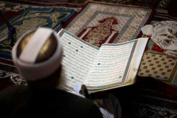 A person reading the Holy Quran A person reading the Holy Quran