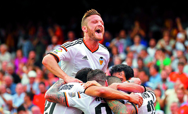 Valencia players celebrate after scoring a goal during their Spanish league match against Eibar at the Mestalla stadium in Valencia on Sunday. Valencia won 2-0. (Photo: AFP) Valencia players celebrate after scoring a goal during their Spanish league match against Eibar at the Mestalla stadium in Valencia on Sunday. Valencia won 2-0. (Photo: AFP)