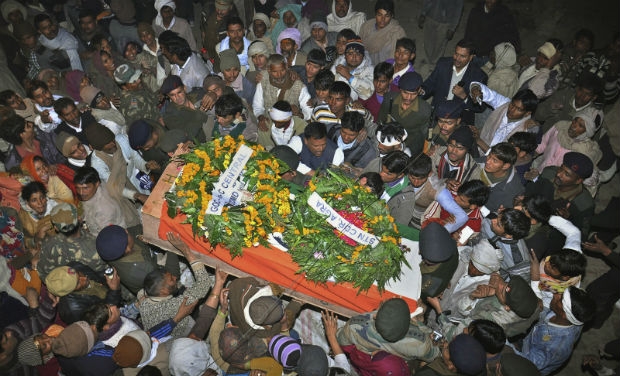 Mourners gather around the body of Indian Army soldier Lance Naik Hamraj who was allegedly killed by Pakistani soldiers on the line-of-control in Kashmir, during his funeral in Mathura district, Uttar Pradesh. (Photo: AP) Mourners gather around the body of Indian Army soldier Lance Naik Hamraj who was allegedly killed by Pakistani soldiers on the line-of-control in Kashmir, during his funeral in Mathura district, Uttar Pradesh. (Photo: AP)