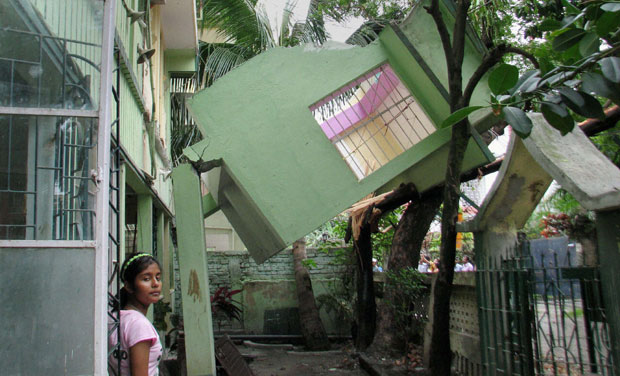 A portion of a residential building collapses following a tremor in Siliguri (Photo: PTI) A portion of a residential building collapses following a tremor in Siliguri (Photo: PTI)