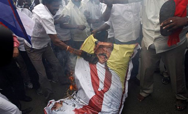 Indian Tamil activists beat a burning effigy of Sri Lankan President Mahinda Rajapaksa during a protest against a Sri Lankan court verdict sentencing five Indian fishermen and three locals to death for smuggling narcotics, in Chennai, India, Friday Indian Tamil activists beat a burning effigy of Sri Lankan President Mahinda Rajapaksa during a protest against a Sri Lankan court verdict sentencing five Indian fishermen and three locals to death for smuggling narcotics, in Chennai, India, Friday