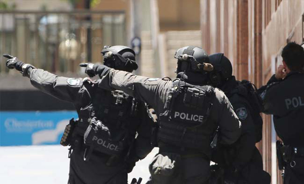 File photo of armed police officers pointing as they stand close to the cafe that was under siege in Sydney (Photo: AP) File photo of armed police officers pointing as they stand close to the cafe that was under siege in Sydney (Photo: AP)