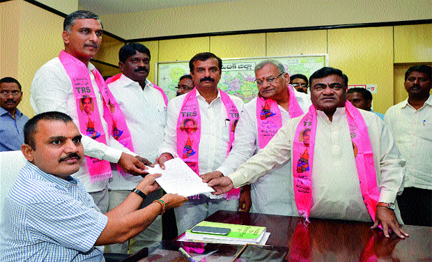 TRS candidate Kotha Prabhakar Reddy submits his nomination papers to retturning officer A. Sarath at the Sngareddy collectorate on Wednesday. Telangana state irrigation minister T. Harish Rao and MLA Babu Mohan are also seen. (Photo: DC) TRS candidate Kotha Prabhakar Reddy submits his nomination papers to retturning officer A. Sarath at the Sngareddy collectorate on Wednesday. Telangana state irrigation minister T. Harish Rao and MLA Babu Mohan are also seen. (Photo: DC)