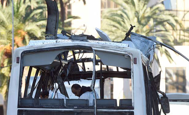 Tunisian forensic police inspect the wreckage of a bus in the aftermath of a bomb attack on a bus transporting Tunisia's presidential guard in central Tunis (Photo: AFP) Tunisian forensic police inspect the wreckage of a bus in the aftermath of a bomb attack on a bus transporting Tunisia's presidential guard in central Tunis (Photo: AFP)
