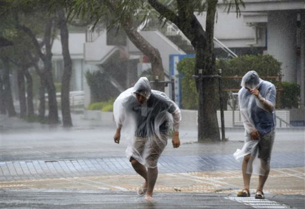 Passersby make their way through strong wind caused by approaching typhoon Vongfong in Naha, Okinawa, southern Japan, Saturday. (Photo: AP) Passersby make their way through strong wind caused by approaching typhoon Vongfong in Naha, Okinawa, southern Japan, Saturday. (Photo: AP)