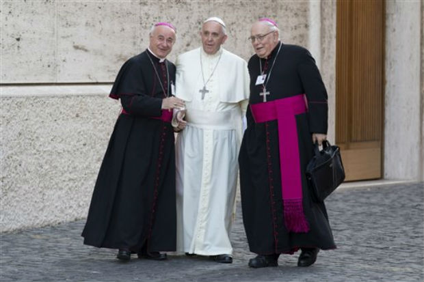 Pope Francis is greeted by bishops Vincenzo Paglia, left, and Jose Maria Arancedo as he arrives for an afternoon session of a two-week synod on family issues, at the Vatican, on Friday. (Photo: AP) Pope Francis is greeted by bishops Vincenzo Paglia, left, and Jose Maria Arancedo as he arrives for an afternoon session of a two-week synod on family issues, at the Vatican, on Friday. (Photo: AP)