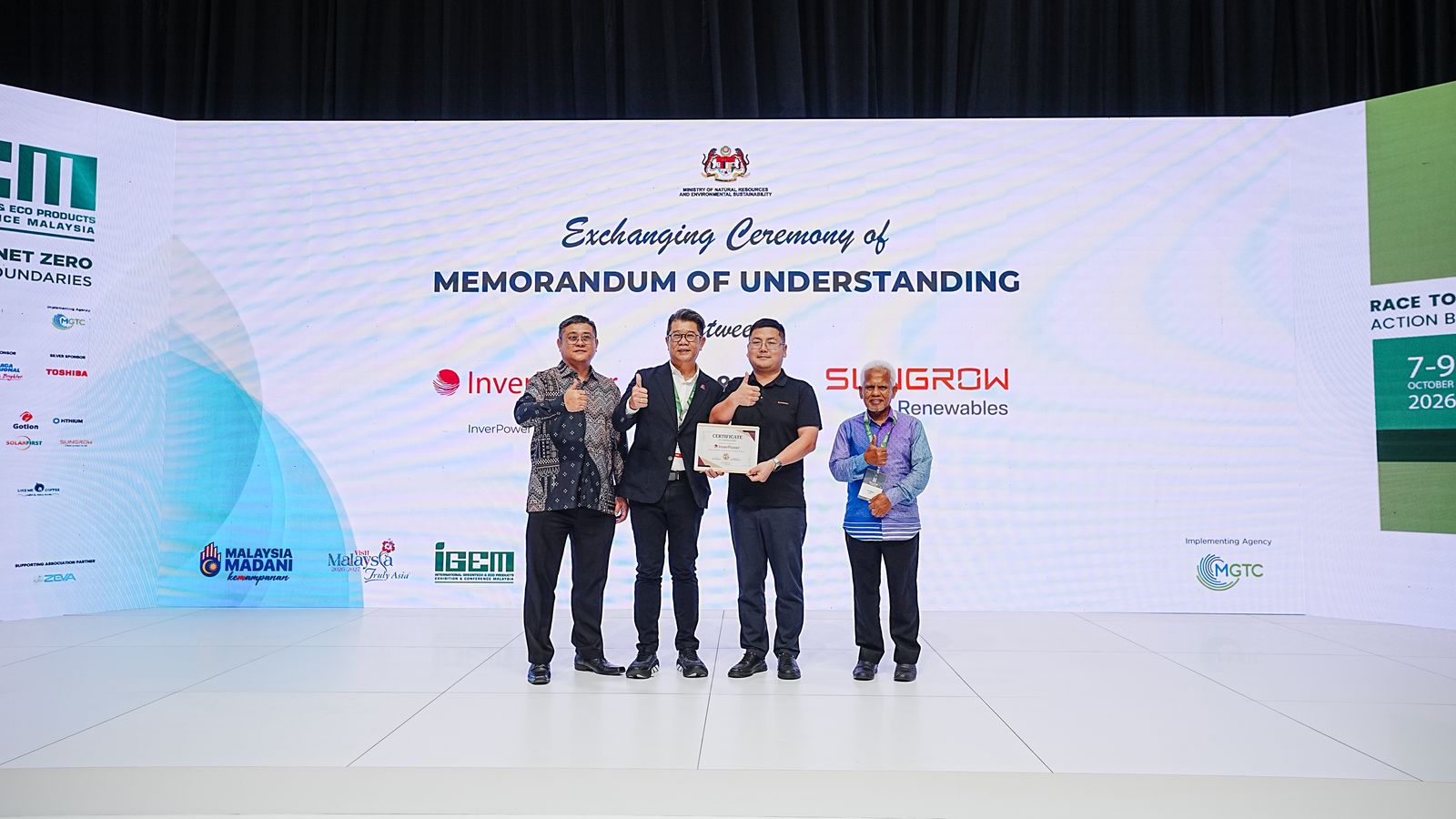 InverPower and Sungrow Renewables representatives holding their MOU certificate on stage at iGEM 2026