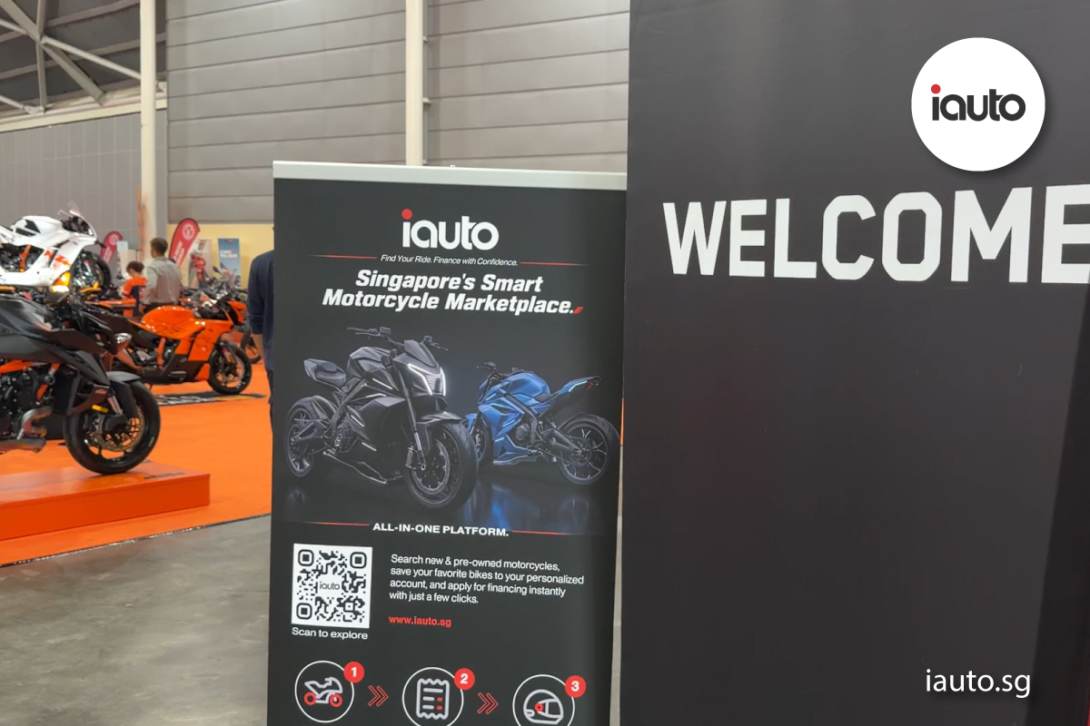 A multi-version vertical banner graphic for iAuto Marketplace at an indoor motorcycle exhibition, featuring a scannable QR code and the text "Singapore's Smart Motorcycle Marketplace."