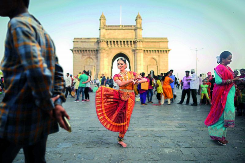 Bharatnatyam dancer placed against chaotic environment and ambiances near the Gateway of India