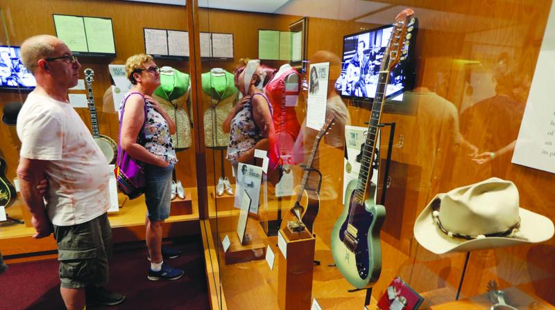 Visitors to the Country Music Hall of Fame and Museum in Nashville, Tennessee, view the Outlaws & Armadillos exhibit