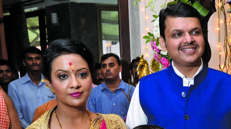 The CM with his wife Amruta, who was also threatened