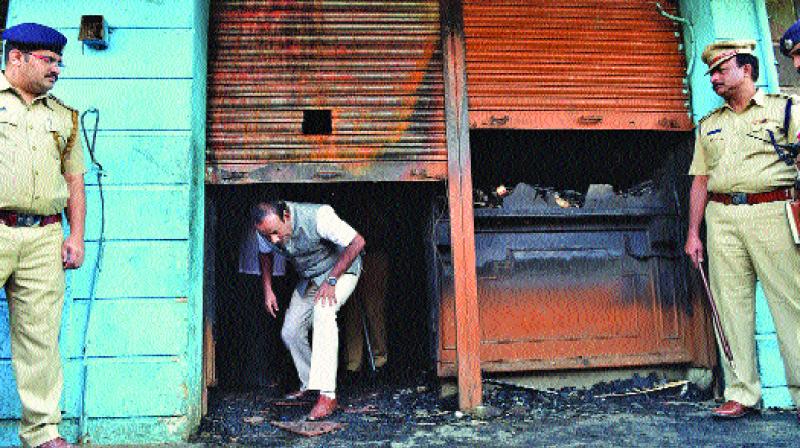 Bengaluru mayor Sampat Raj comes out after inspecting the spot after a fire broke out at a bar-cum-restaurant, in Bengaluru. (Photo: PTI)