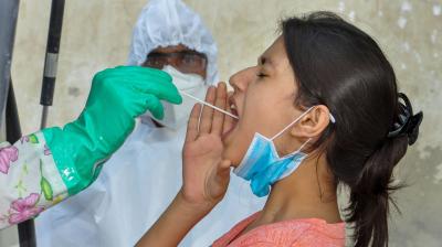 A medic collects a swab sample from a young woman for COVID-19 test, during Unlock 2.0, in Kullu district, Friday. PTI photo