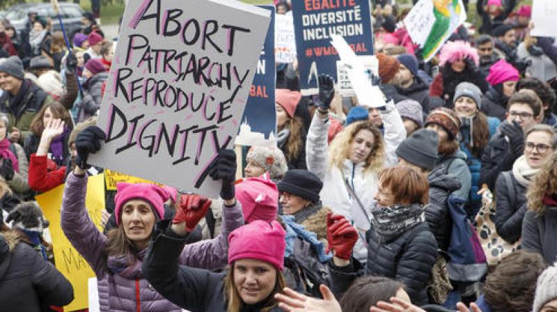 Protesters hold placards with slogans, during the Womens March rally, in Geneva. (Photo: AP)