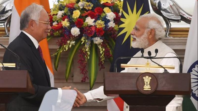 Prime Minister, Narendra Modi with his Malaysian counterpart Najib Razak shakes hands after their joint statement at Hyderabad House, in New Delhi on Saturday. (Photo: PTI)