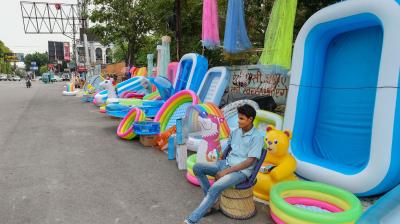  Roadside vendors selling inflatable pools and other items wait for customers, as shops are being opened gradually amid ongoing COVID-19 lockdown. PTI Photo
