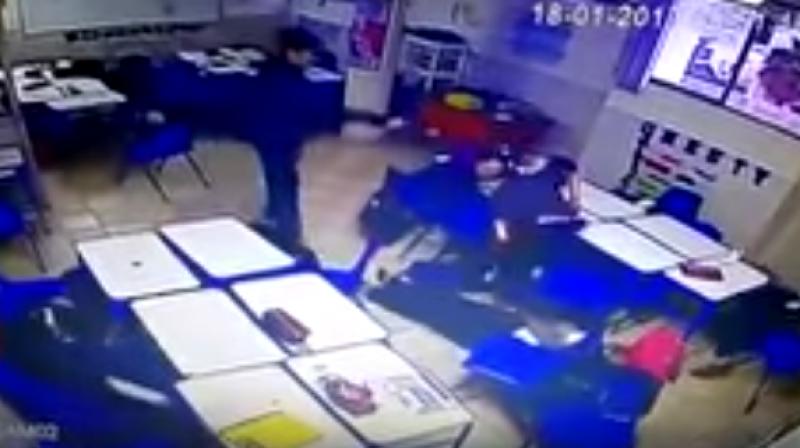 A video, apparently from the schools surveillance camera, shows a female teacher handing out materials and students seated at their desks when a boy opens fire with a pistol from a sitting position. (Photo: Videograb)