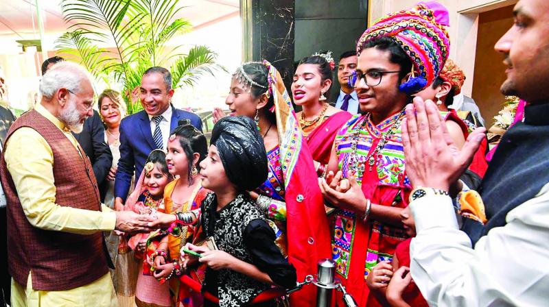 Prime Minister Narendra Modi being enthusiastically welcomed by the Indian community in Manama in Bahrain on Saturday. 	(Photo: PTI)