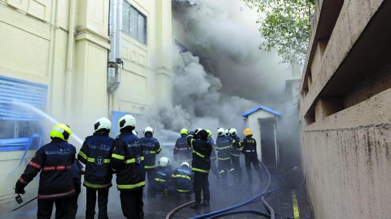 Firefighters try to douse a level-2 fire which broke out at Sadhana House, behind Mahindra Towers in Worli. (Photo: Rajesh Jadhav)