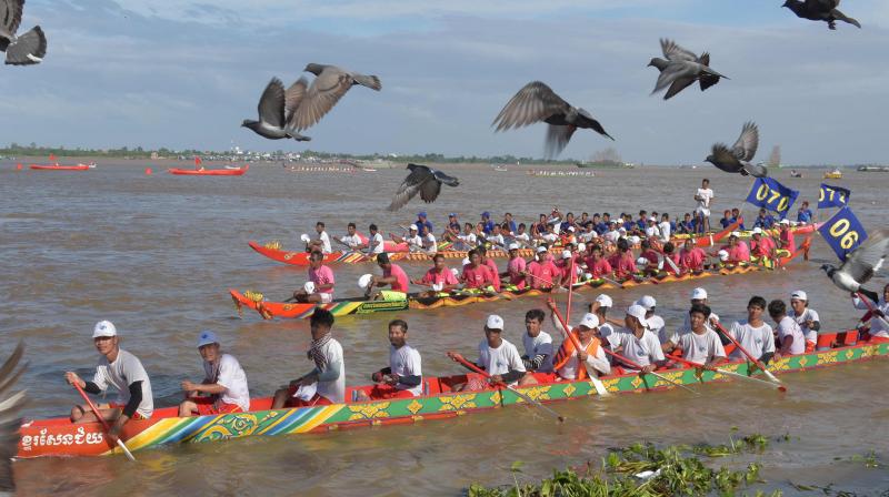 Cambodian participants row their dragon boats during the annual water festival