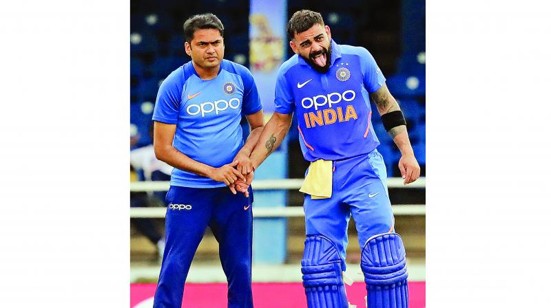 Virat Kohli grimaces in pain after injuring his right thumb while batting in the third ODI. (Photo: AP)