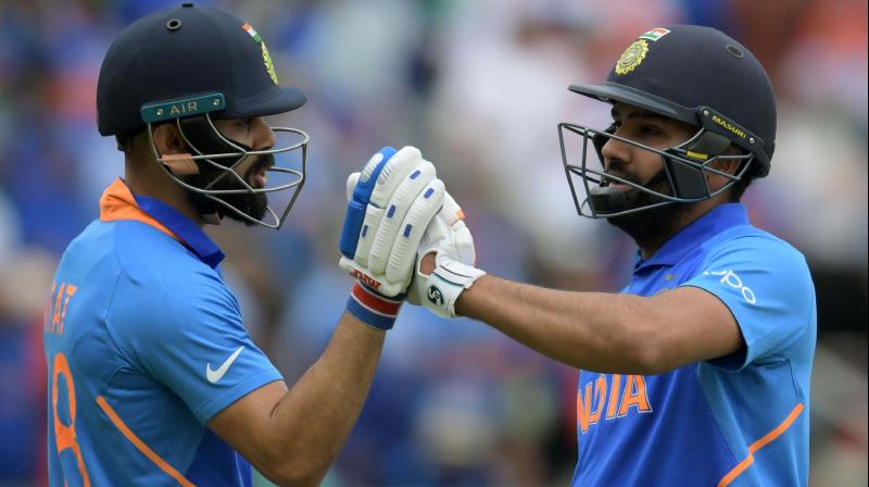 Virat Kohli congratulates Rohit Sharma during the match against Bangladesh. Virat Kohli congratulates Rohit Sharma during the match against Bangladesh.