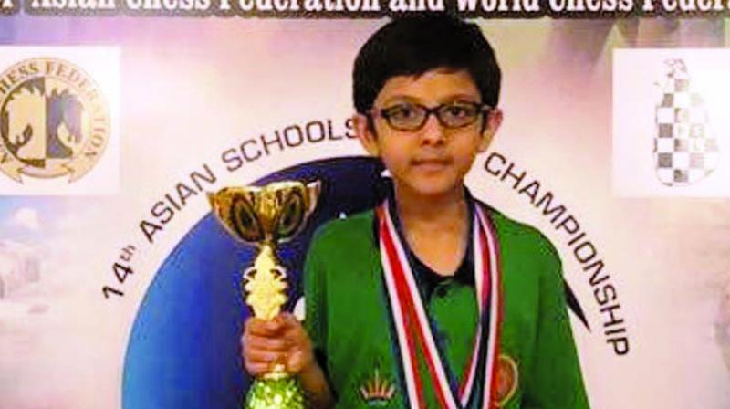 Aryaveer Agarwal of Mumbai poses with his individual silver medal and team gold medal and the trophy.