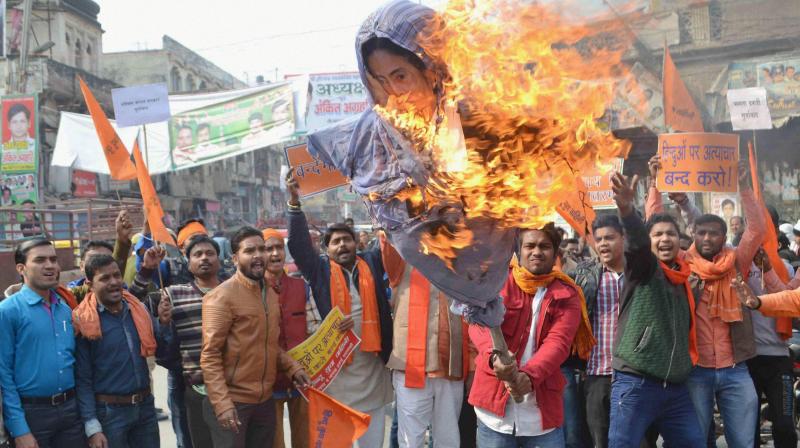 Hindu yuva vahini workers burn rffigy of West Bengal CM Mamata Bannerjee, in Varanasi on Tuesday. (Photo: PTI)