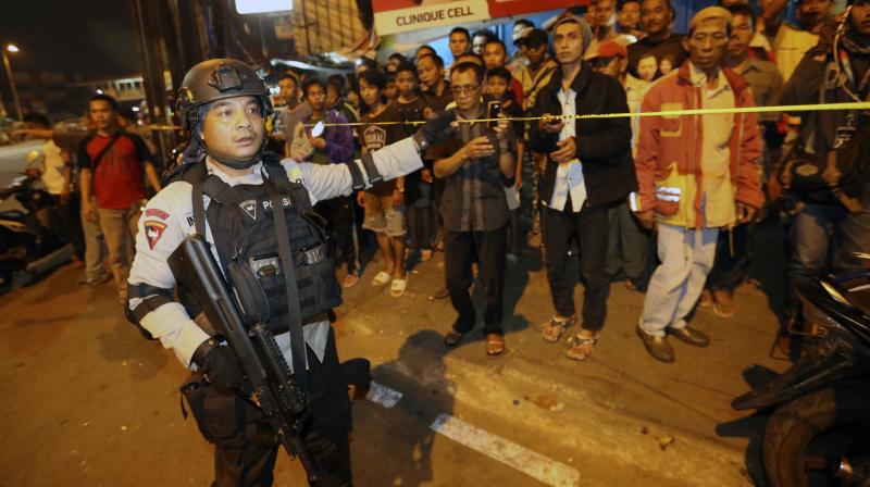 Police officers clear the scene after an explosion near a bus stop in the Kampung Melayu area of Jakarta, Indonesia. (Photo: AP0
