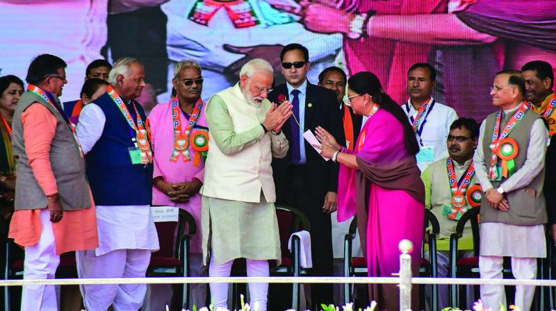 PM Narendra Modi being greeted by former Rajasthan CM Vasundhara Raje at a public meeting in Tonk. (Photo: PTI)