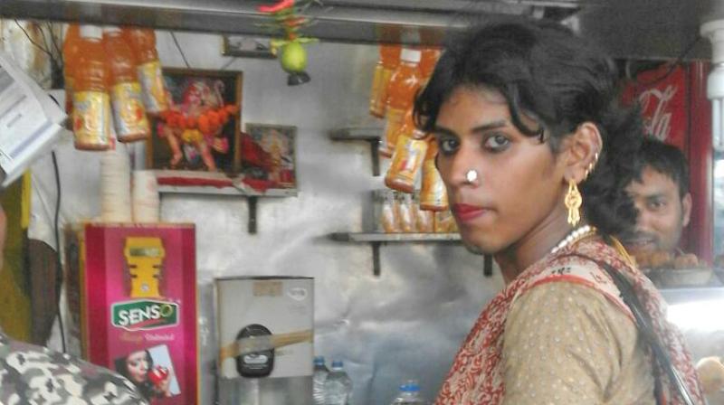 Durga, a eunuch, giving a shopkeeper change on Sunday in lieu of a tip.