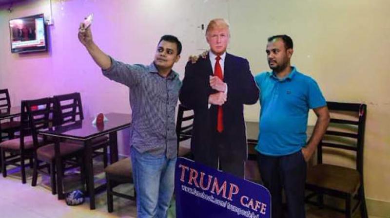 Politics appears to be last thing on many diners minds as they pose for photos with a cardboard cutout of the US president, placed strategically at the entrance by 29-year-old businessman Islam. (Photo: AFP)