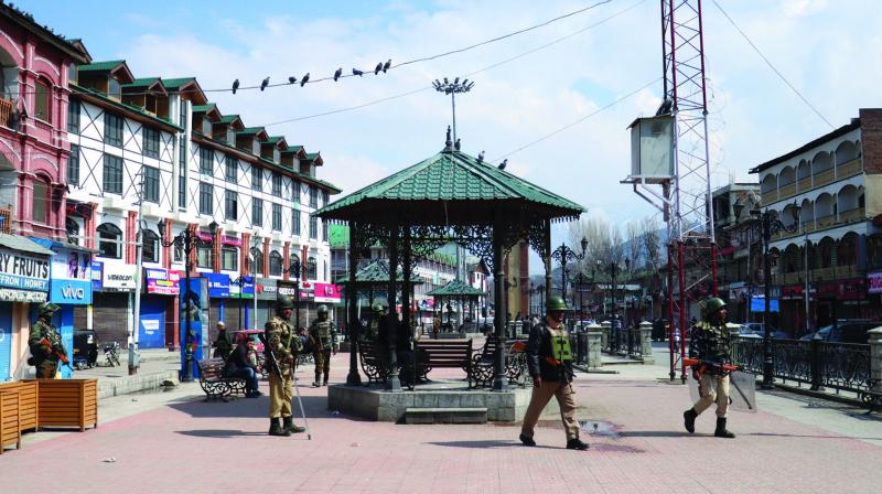 A file photo of security personnel keeping an eye on the mischievous elements in Srinagar. 