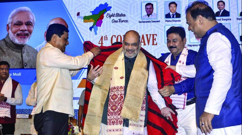 Union home minister Amit Shah is feliciated by Assam chief minister Sarbananda Sonowal during the 4th conclave of the North East Democratic Alliance (NEDA) in Guwahati on Monday. (Photo: PTI) Union home minister Amit Shah is feliciated by Assam chief minister Sarbananda Sonowal during the 4th conclave of the North East Democratic Alliance (NEDA) in Guwahati on Monday. (Photo: PTI)