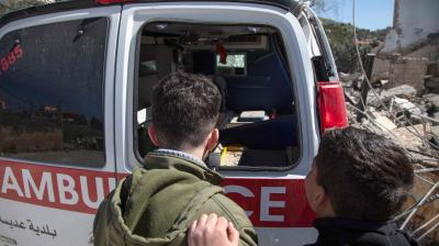 Youths inspect a damaged ambulance at the site of an Israeli airstrike a day earlier in the southern Lebanese village of Odaisseh near the border with Israel on March 5, 2024, amid ongoing cross-border tensions as fighting continues between Israel and Palestinian Hamas militants in the Gaza Strip. (AFP)