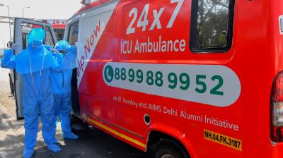 In this photograph taken on May 24, 2020, ambulance staff from HelpNow put on protective gear before starting a transport journey in Mumbai. As coronavirus hotspot Mumbai grapples with crippling healthcare shortages, an ambulance service founded by three students is trying to fill the gap in India's worst-hit city. But many patients are too poor to pay for the life-saving trip. (Photo | AFP)