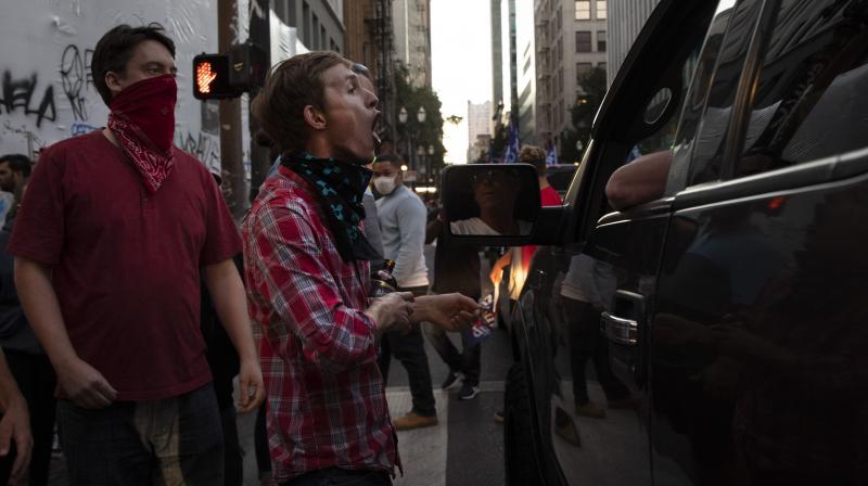 A Black Lives Matter protester yells at a supporter of President Donald Trump during a rally and car parade Saturday, Aug. 29, 2020, in Portland. (AP) A Black Lives Matter protester yells at a supporter of President Donald Trump during a rally and car parade Saturday, Aug. 29, 2020, in Portland. (AP)