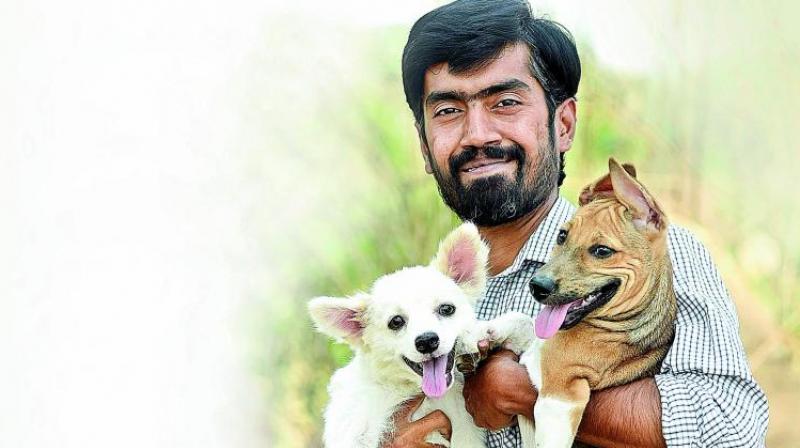 Pradeep with his paralysed pomeranian Bablu and injured dog Gigi
