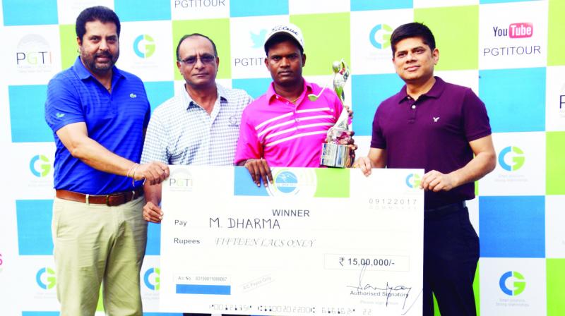 M. Dharma (second from left), holding the winners trophy and cheque. M. Dharma (second from left), holding the winners trophy and cheque.