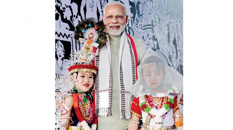 PM Narendra Modi with children dressed in traditional Manipuri attire at an exhibition in Imphal. (Photo: PTI)