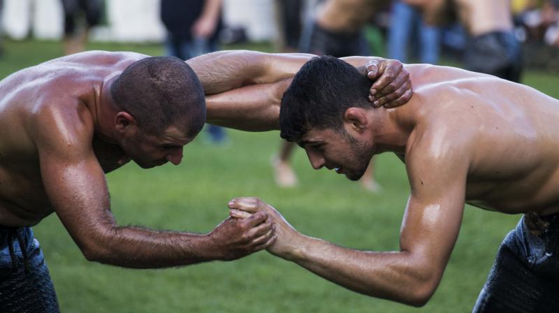 Traditional oil wrestling competition held in Greek village of Sochos