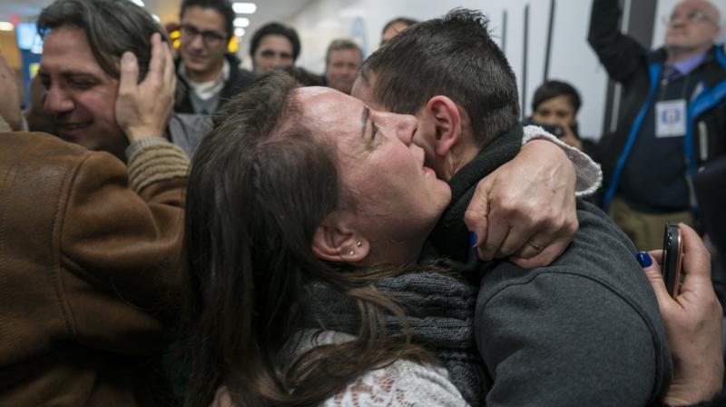 Hugs and tears: Visa holders scramble to enter US after Trumps ban reversed