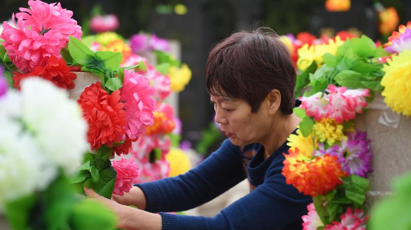 On Tomb Sweeping Day, People in China tend the graves of their departed loved ones