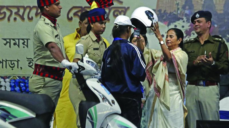 CM Mamata Banerjee presents a helmet during a development programme in Birbhum on Thursday. (Photo: PTI) CM Mamata Banerjee presents a helmet during a development programme in Birbhum on Thursday. (Photo: PTI)