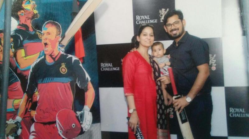 Baby Agafya with her proud parents at a makeshift studio for a family photo.